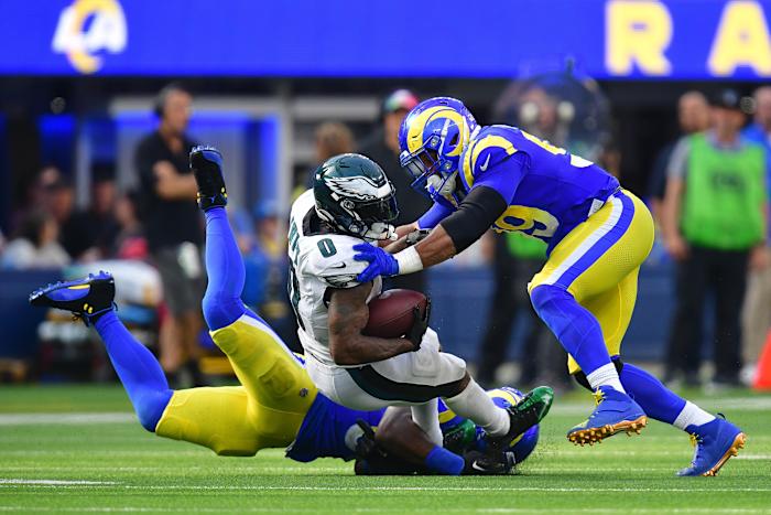 Oct 8, 2023; Inglewood, California, USA; Philadelphia Eagles running back D'Andre Swift (0) is brought down by Los Angeles Rams defensive tackle Aaron Donald (99) during the second half at SoFi Stadium. Mandatory Credit: Gary A. Vasquez-USA TODAY Sports